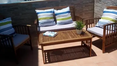 a patio with two chairs and a table with a couch at CASA MARINA DE LA BAHIA in Puerto Real