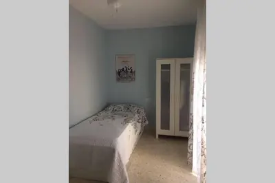 a small bedroom with a bed and a window at CASA MARINA DE LA BAHIA in Puerto Real