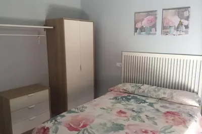 a bedroom with a bed and a dresser at CASA MARINA DE LA BAHIA in Puerto Real