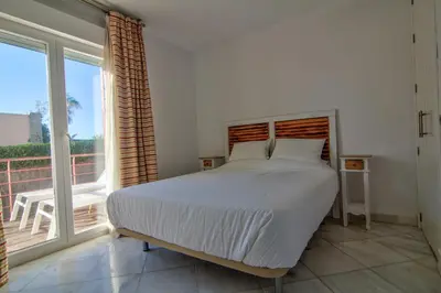 a bedroom with a bed and a large window at Altair 11 in El Puerto de Santa María