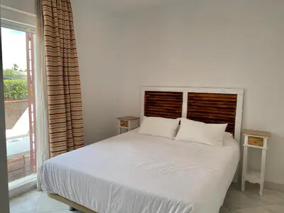 a white bed in a bedroom with a window at Altair 11 in El Puerto de Santa María