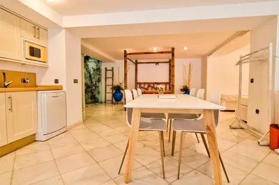 a kitchen and dining room with a table and chairs at Altair 11 in El Puerto de Santa María