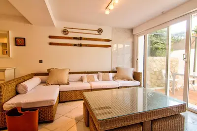 a living room with a couch and a glass table at Altair 11 in El Puerto de Santa María