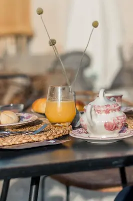 a table with plates of food and a glass of orange juice at Hotel Bodega Tio Pepe in Jerez de la Frontera