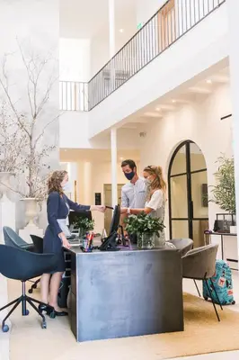 a group of people working at a desk in an office at Hotel Bodega Tio Pepe in Jerez de la Frontera