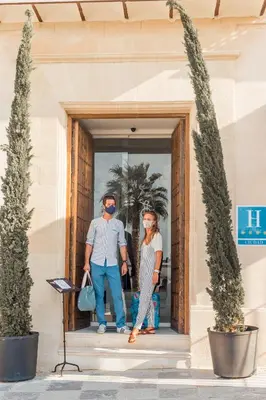 a man and a woman standing in the doorway of a building at Hotel Bodega Tio Pepe in Jerez de la Frontera