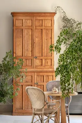 a wooden cabinet with chairs and a table in front of it at Hotel Bodega Tio Pepe in Jerez de la Frontera