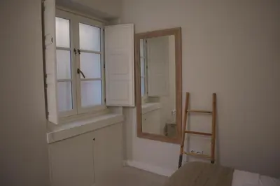 a room with a mirror and a window and a ladder at LOFTS MIRIAM CONDE O,REILLY in Cádiz