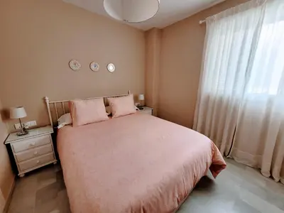 a bedroom with a large bed and a window at Novo Sancti Petri - Playa, Piscina, Golf y Relax in Chiclana de la Frontera
