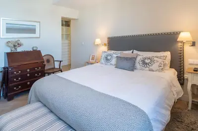 a bedroom with a large bed and a dresser at Phoenix Luxury Loft Cádiz in Cádiz