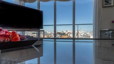 a living room with a large window with a view of a city at Phoenix Luxury Loft Cádiz in Cádiz
