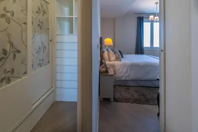 a bedroom with a bed and a door leading into a room at Phoenix Luxury Loft Cádiz in Cádiz