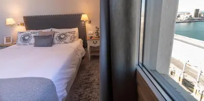 a bedroom with a bed next to a window at Phoenix Luxury Loft Cádiz in Cádiz