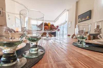a wooden table with wine glasses on top of it at Phoenix Luxury Loft Cádiz in Cádiz