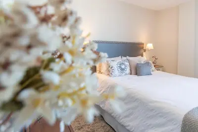 a bedroom with a bed with white sheets and pillows at Phoenix Luxury Loft Cádiz in Cádiz