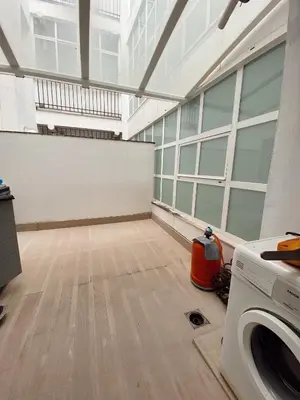 an empty room with a washing machine in a building at Beautiful & Cozy Apart. Pool & Parking-Downtown in Sanlúcar de Barrameda