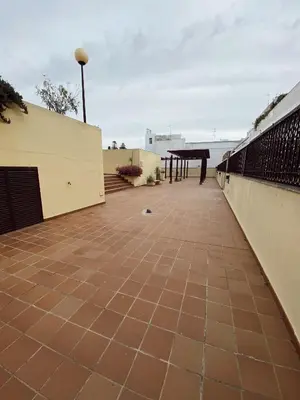 a patio with a table on the roof at Beautiful & Cozy Apart. Pool & Parking-Downtown in Sanlúcar de Barrameda