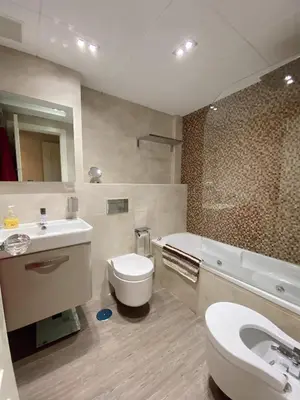 a bathroom with a sink and a toilet and a tub at Beautiful & Cozy Apart. Pool & Parking-Downtown in Sanlúcar de Barrameda