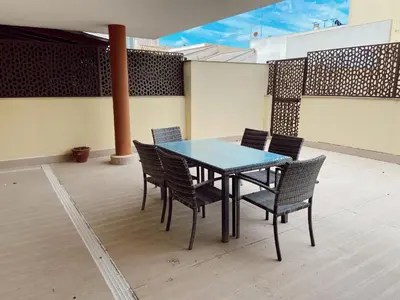 a blue table and chairs on a patio at Beautiful & Cozy Apart. Pool & Parking-Downtown in Sanlúcar de Barrameda
