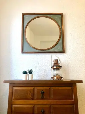 a mirror on a wall above a wooden dresser at GATU Villa Cielo y Mar junto la playa, terraza , wifi y vista al mar ,