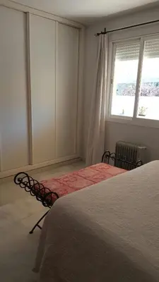 a bedroom with two beds and a window at Bonito Ático en el centro de la ciudad in Sanlúcar de Barrameda