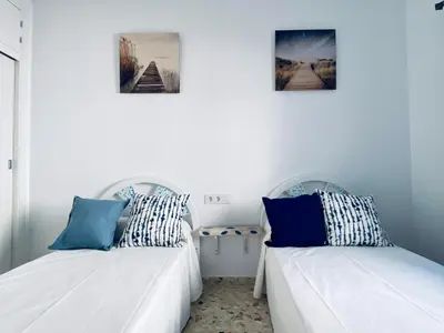 two beds sitting next to each other in a room at Ramón y Cajal 6 in Chipiona