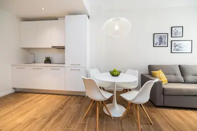 a living room with a table and chairs and a couch at Tandem Puerto Chico in Cádiz