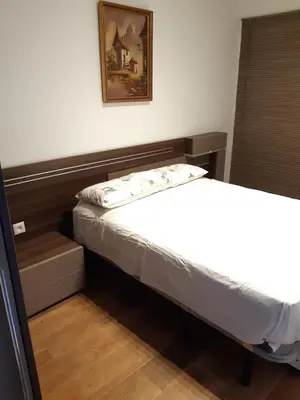 a small bedroom with a bed and a picture on the wall at Apartamento Zona Carrefour in El Puerto de Santa María