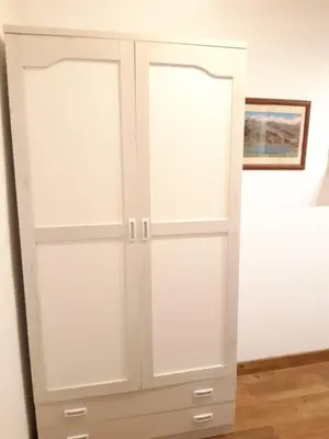 a white cabinet with two doors in a room at Apartamento Zona Carrefour in El Puerto de Santa María