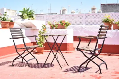 two chairs and a table on a balcony at Apartamento La Discusión de Veedor 12 in Cádiz