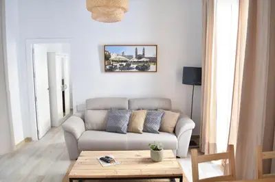 a living room with a couch and a coffee table at Apartamento La Discusión de Veedor 12 in Cádiz