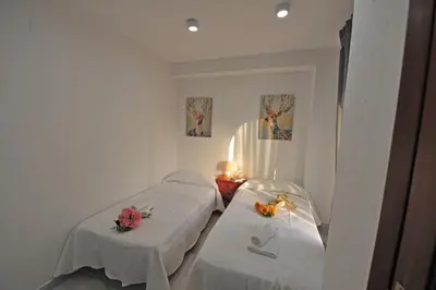 a bedroom with two beds with flowers on them at Playa Santa María 3 Dormitorios 2 Baños in Cádiz