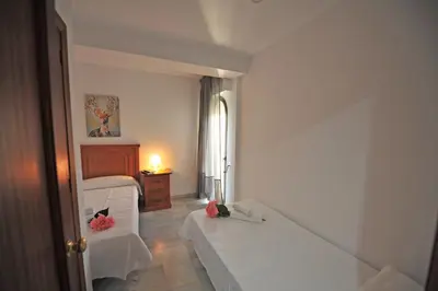 a white room with a bed and a window at Playa Santa María 3 Dormitorios 2 Baños in Cádiz