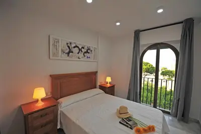 a bedroom with a bed and a large window at Playa Santa María 3 Dormitorios 2 Baños in Cádiz
