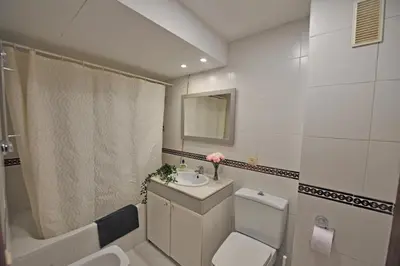 a bathroom with a sink and a toilet and a mirror at Playa Santa María 3 Dormitorios 2 Baños in Cádiz