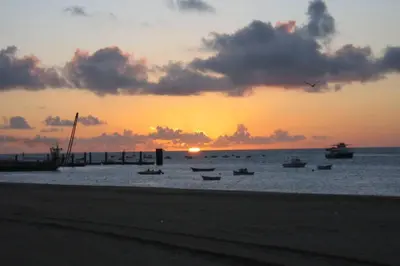 a group of boats in the water at sunset at Sanlucar Misericordia Centro in Sanlúcar de Barrameda