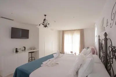 a bedroom with a bed with white clothes on it at El Tesorillo II in Arcos de la Frontera