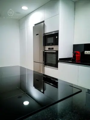 a kitchen with a stainless steel refrigerator and microwave at El Tesorillo II in Arcos de la Frontera