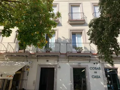 a white building with balconies on top of it at Sibilina House centro Jerez in Jerez de la Frontera