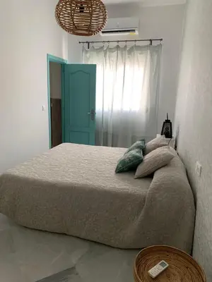 a bedroom with a large bed with a blue door at Sibilina House centro Jerez in Jerez de la Frontera