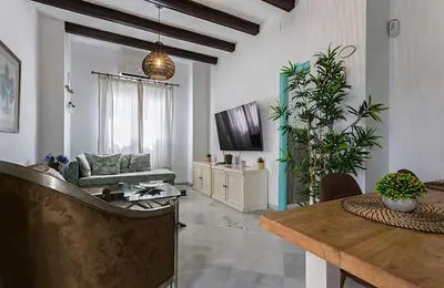a living room with a couch and a table at Sibilina House centro Jerez in Jerez de la Frontera