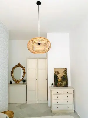 a room with a dresser and a chandelier at Sibilina House centro Jerez in Jerez de la Frontera