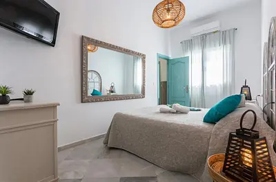 a bedroom with a bed and a mirror at Sibilina House centro Jerez in Jerez de la Frontera
