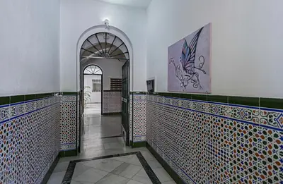 a hallway with blue and white tiled walls and an entry way at Sibilina House centro Jerez in Jerez de la Frontera