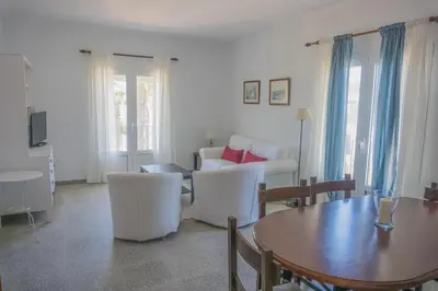 a living room with a table and a couch at Amplio alojamiento con magnificas vista a 6 metros de la playa in Chipiona