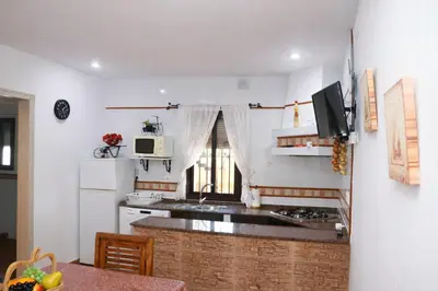 a kitchen with a sink and a counter top at Chalet 2 dormitorios con piscina privada in Conil de la Frontera