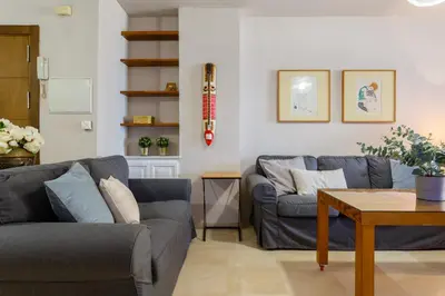 a living room with two blue couches and a table at BLUE Atlantic Family Home by Cadiz4Rentals in Cádiz