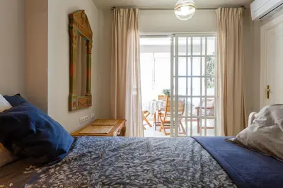 a bedroom with a bed and a view of a patio at BLUE Atlantic Family Home by Cadiz4Rentals in Cádiz