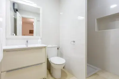 a bathroom with a toilet and a sink and a shower at BLUE Atlantic Family Home by Cadiz4Rentals in Cádiz