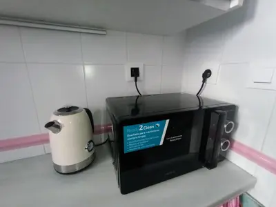 a microwave sitting on a counter next to a toaster at Cielo y Mar infinito in El Puerto de Santa María